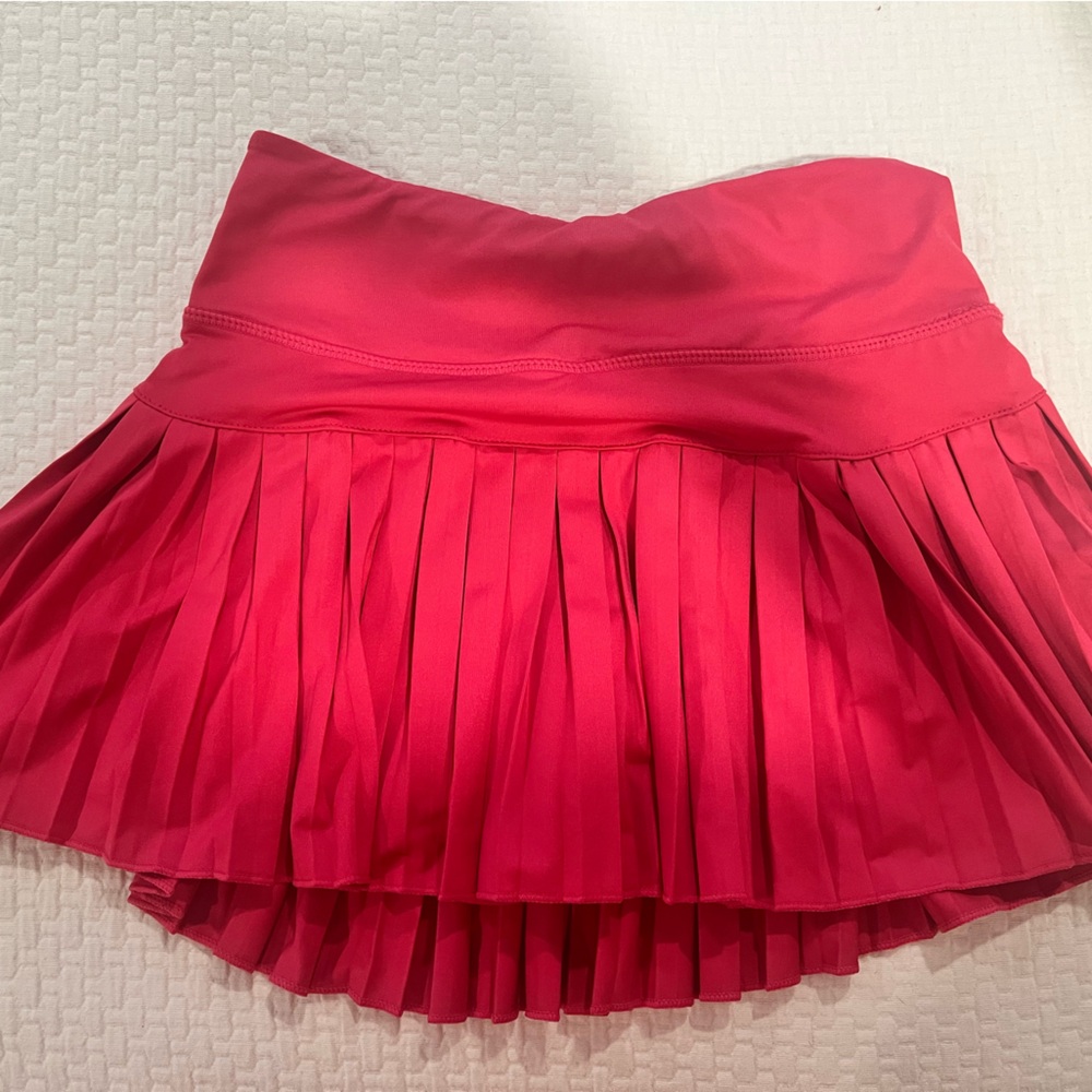 Gold hindge hot pink skirt.